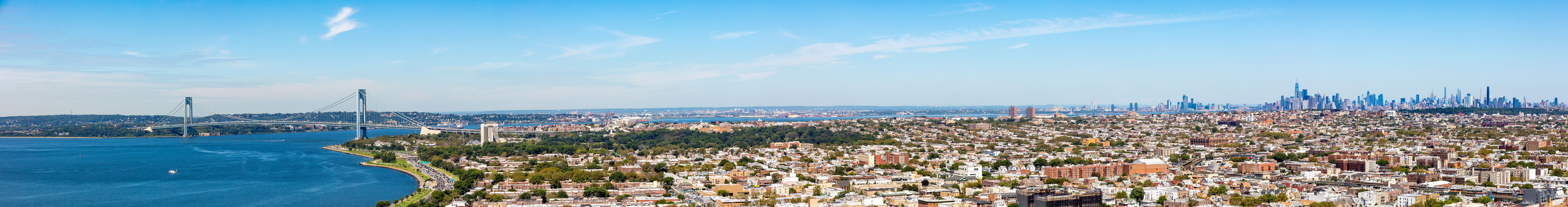 Wide panorama of views showing city, bridge and river